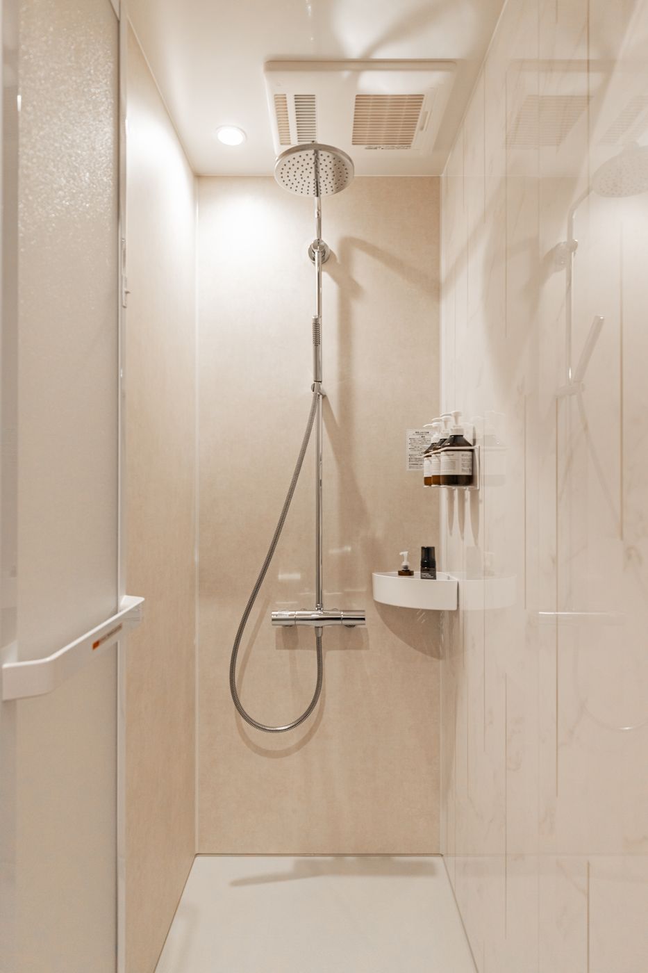 A separate shower room with light stone walls