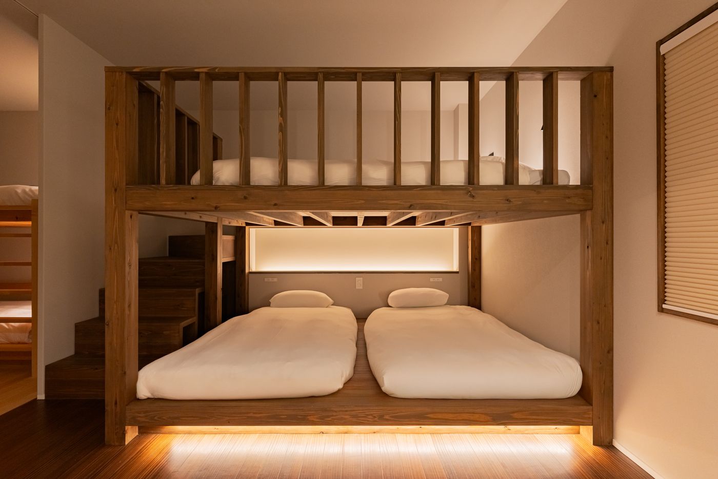 Bedroom one: a timber bunk bed with soft light beneath the lower bunk