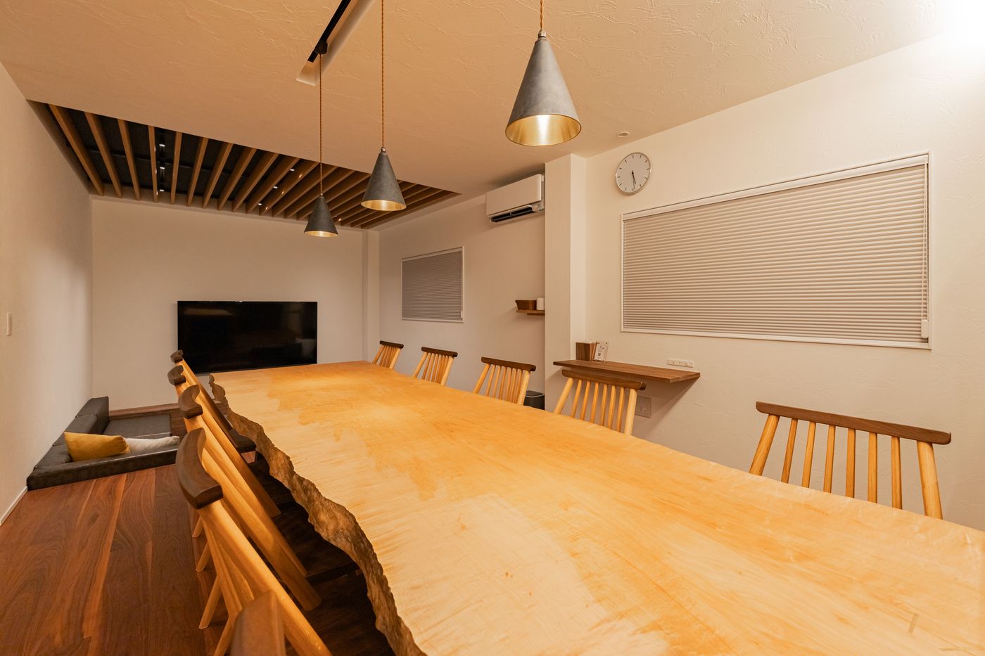 The live-edge wooden dining table in evening light