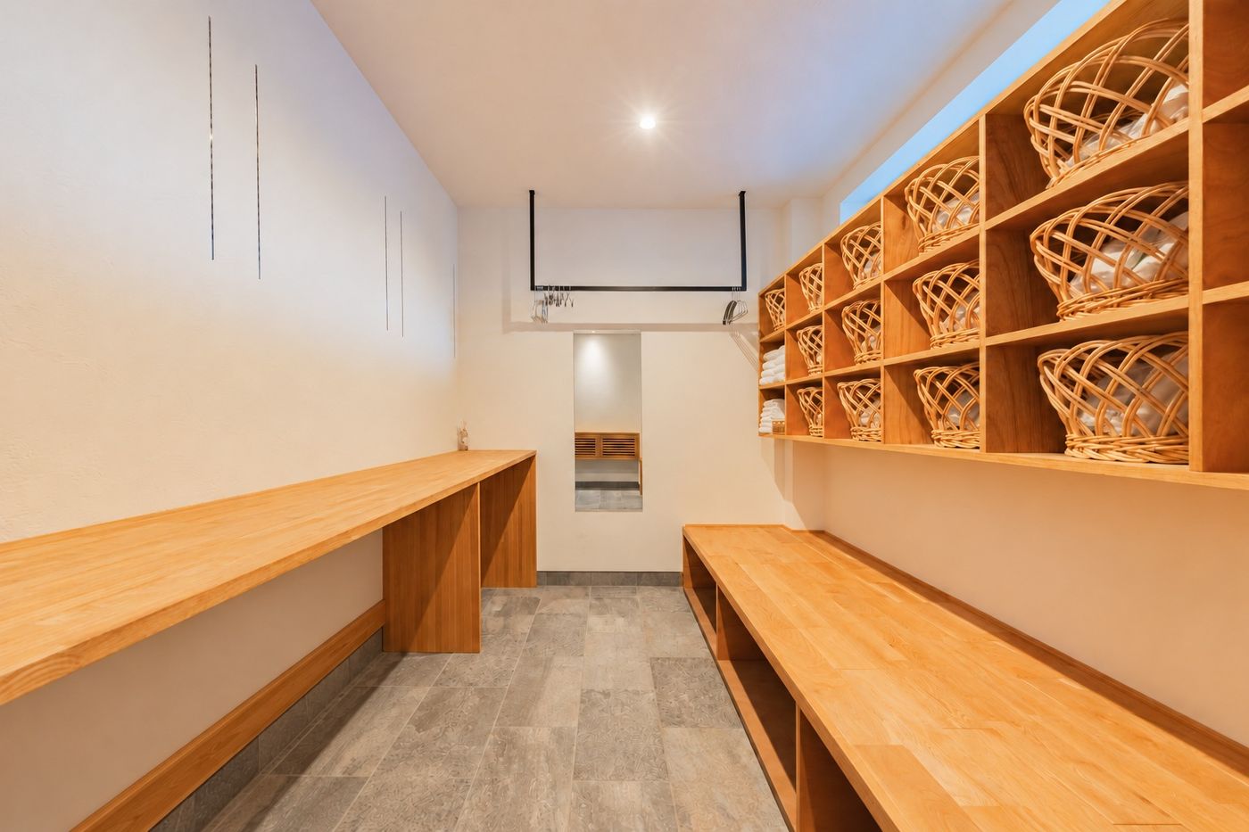 The trunk room: a long wooden counter on one side, a bench and a wall of woven baskets on the other
